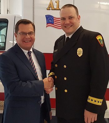 Norman Dascher, CEO of Samaritan Hospital and St. Mary's Hospital, stands with Forest Weyen, executive director of the Bennington Rescue Squad, at a ceremony on May 22 to celebrate the squad receiving a Mission Lifeline Gold Award from the American Hearty Association.