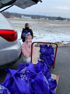 Brinley and her older brother, Bryden help deliver bags