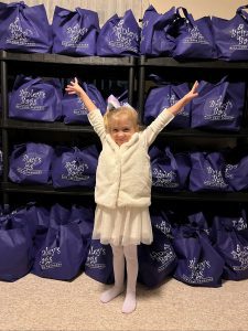 Brinley poses with bags